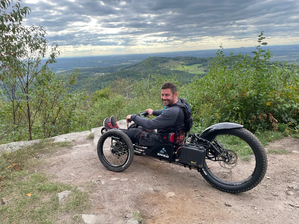 Philippe Bédard on a Bowhead handcycle at a mountain overlook